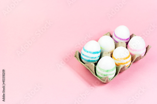 Colorful Easter eggs on a pink background. Copy space. Celebrating Easter