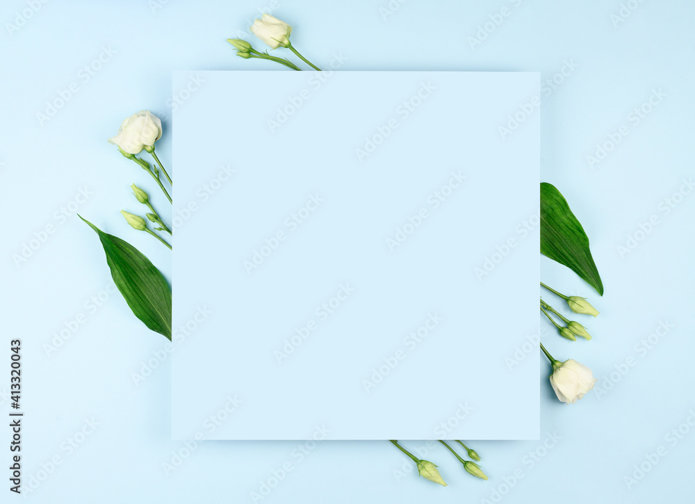 Spring composition. White flowers, paper blank on pastel blue background. Flat lay, top view, copy space, mock up. Spring composition. White flowers, paper blank on pastel blue background. Flat lay, top view, copy space, mock up.
