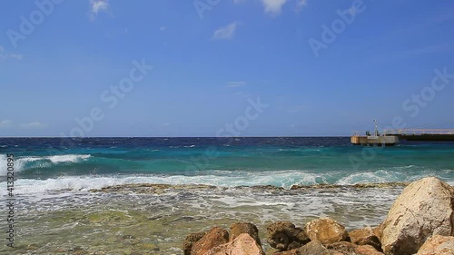 Coastline of Caribbean island with cruise ship in port on sunny day