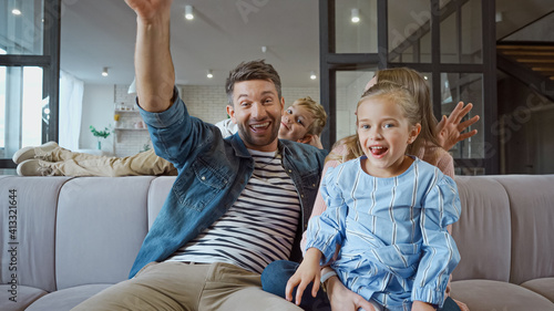 Cheerful family spending time on sofa at home