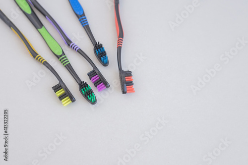 Set of multicolored toothbrushes on gray background