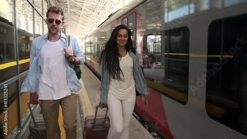 young people are travelling by train, going over station with baggage