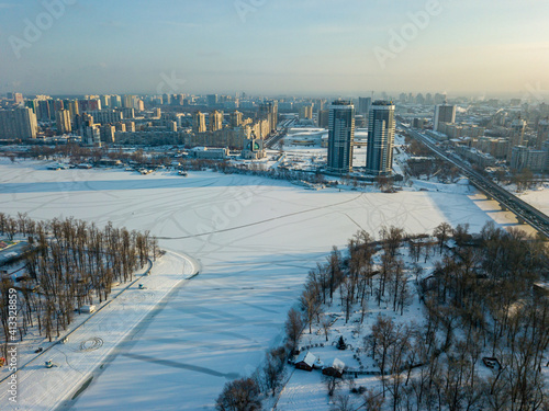 The frozen Dnieper river in Kiev. Aerial drone view. Winter sunny frosty morning.