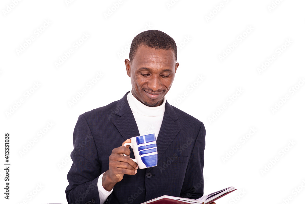 Close-up of a handsome businessman with diary and cup of coffee, smiling. Close-up of a handsome businessman with diary and cup of coffee, smiling.