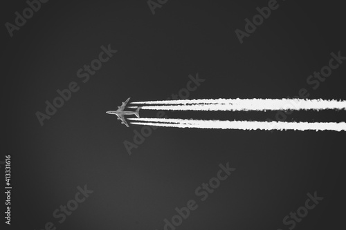 Aircraft and its Condensation Trail. Aircraft emissions in black and white