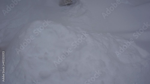 The man shovels snow into a pile after a blizzard