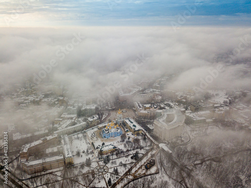 Fog over the snow-covered St. Michael's Cathedral in Kiev. Aerial drone view. Foggy winter day.