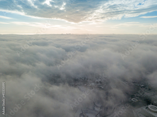 Fog over the snowy Kiev city. Aerial drone view. Foggy winter day. © Sergey