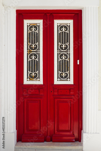 Fototapeta Naklejka Na Ścianę i Meble -  one of the charm of the Greek Cycladic islands in the heart of the Aegean Sea, are the beautiful colored doors of the houses of the narrow streets of ancients cities