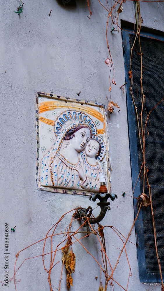 Madonna statue on the wall of the brightly coloured