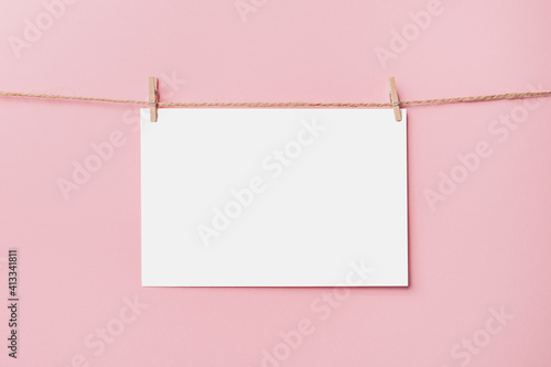 note letter pin on rope on pink background, love and valentine concept