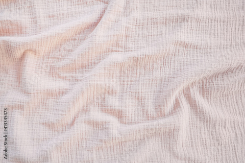Muslin cloth texture background in neutral tones. Muslin cotton fabric of plain weave. Muslin is a soft, woven, 100-percent cotton multi-layer cloth popular for baby cloths and blankets