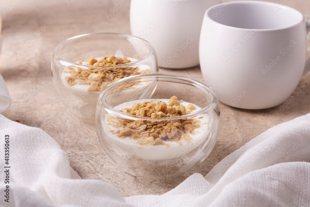 Granola muesli in glass glasses on a beige background. Close up. Granola muesli in glass glasses on a beige background. Close up.