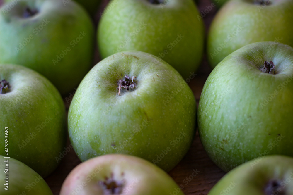 Apples stand on a wooden surface