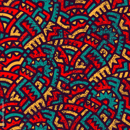 Seamless african pattern. Ethnic and tribal motifs. Orange, red, yellow, blue and black colors. Grunge texture. Vintage print for textiles. Bohemian hand-drawn ornament. Vector illustration.