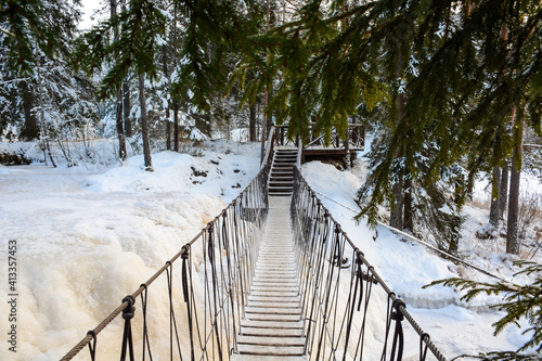 RUSKEALA, RUSSIA- JANUARY 15, 2021: Rope bridge through Ruskeala Waterfalls in winter