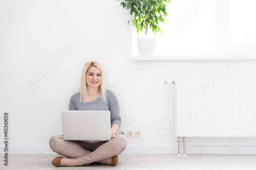 young beautiful woman using a laptop computer at home