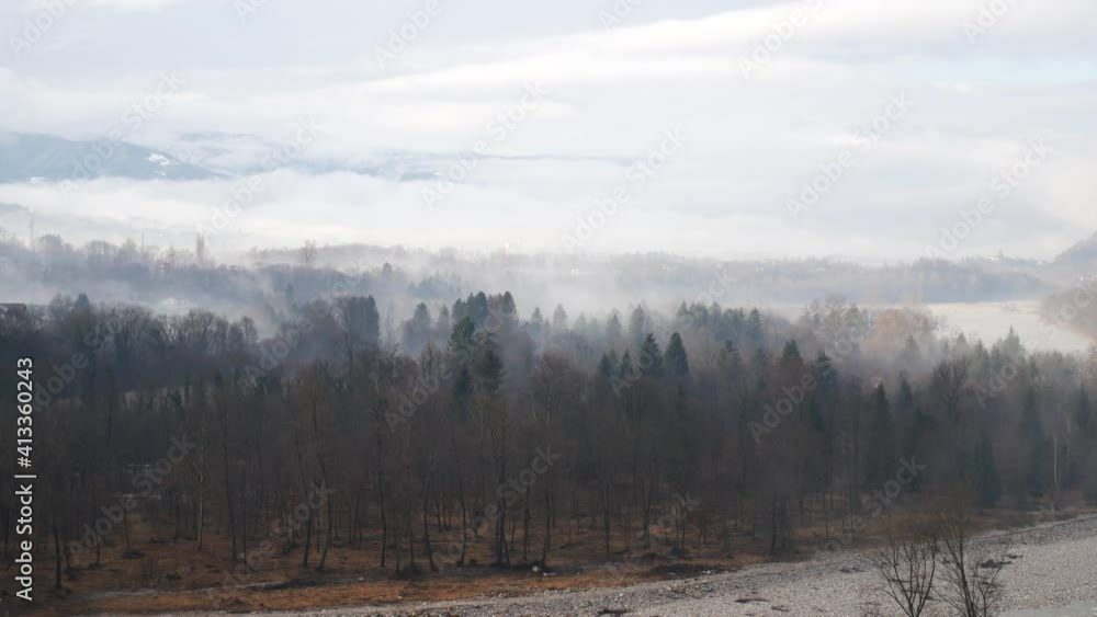 time lapse video of the morning sun over the woods by the river