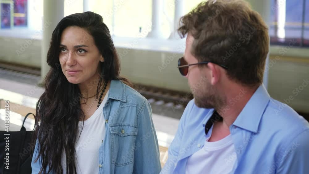 Happy couple having rest at the train station