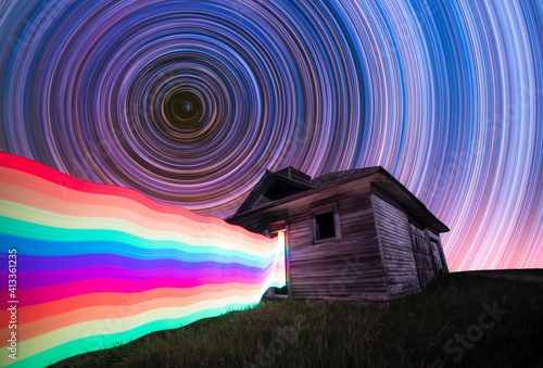 Long exposure, light painting night photography. Star trails and rainbow