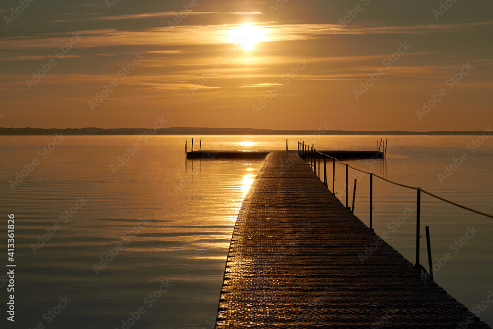 Beautiful sunrise over the lake. Ladder to the lake.