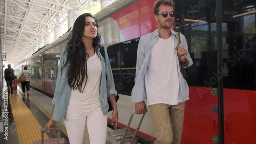 Couple walking along the platform at the railway station