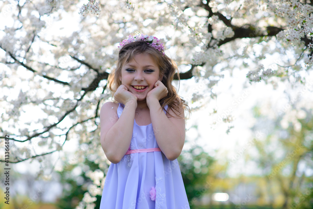 Pretty little girl in blooming apple tree garden on beautiful spring day Pretty little girl in blooming apple tree garden on beautiful spring day