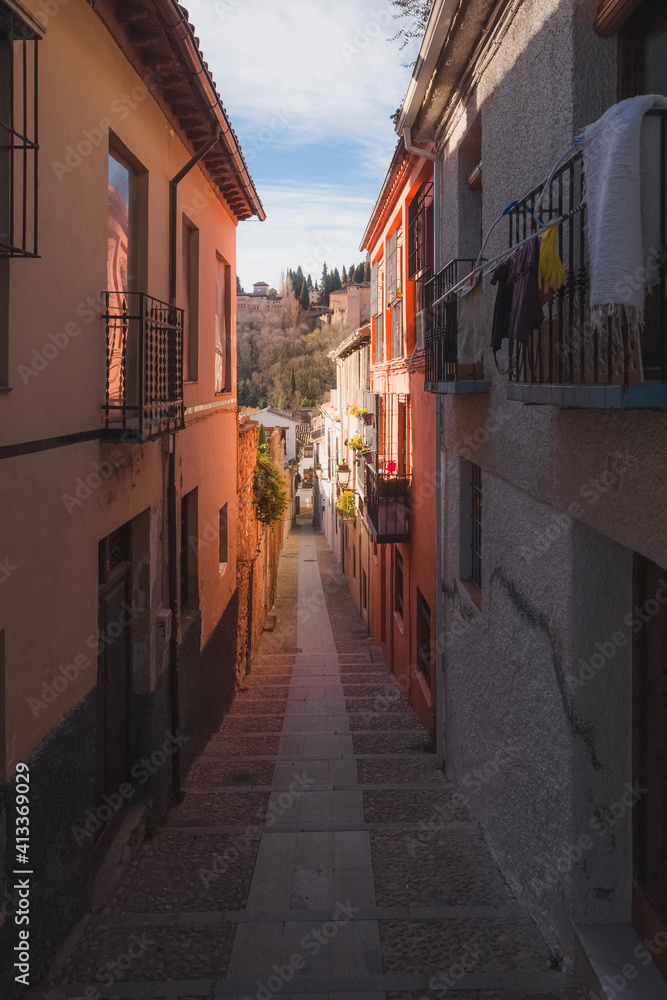 Quiet and quaint narrow streets in old town (Albaicin or Arab Quarter) Granada, Spain, Andalusia with views towards the Alhambra.
