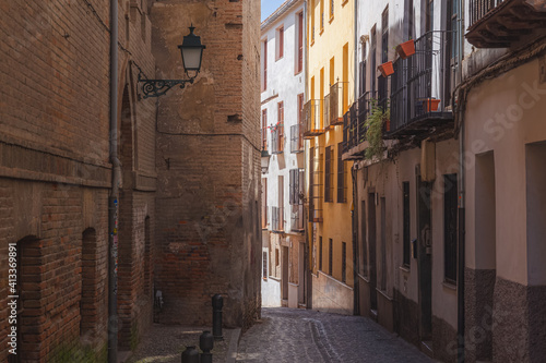 Narrow cobblestone backstreet in old town  Albaicin or Arab Quarter  in Granada  Andalusia  Spain.