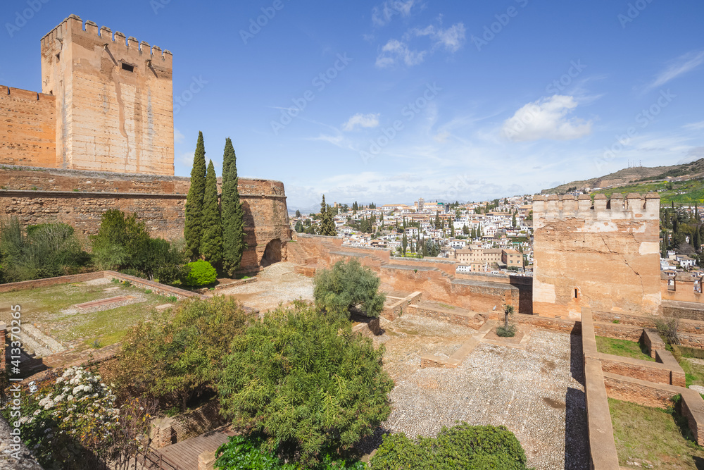 A view over old town Granada (Albaicin or Arab Quarter), in Andalusia, Spain on a clear sunny day from the gardens of Charles V Palace at the historic Alhambra.