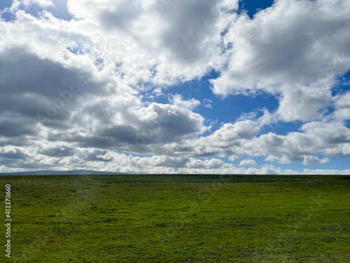 Green Grassland with Storm Cloudy Blue Sky Leaving the Bay Area. Bixby Park, Palo Alto, California.
