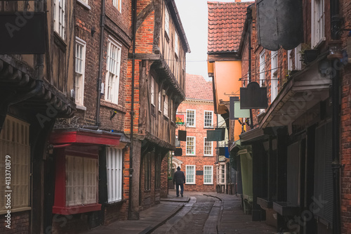The Shambles in old town York, featuring traditional medieval timber frame overhang buildings, is a popular tourist attraction and shopping area in Yorkshire, England, UK.
