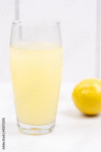 Homemade Lemonade in the glass with lemons on the table