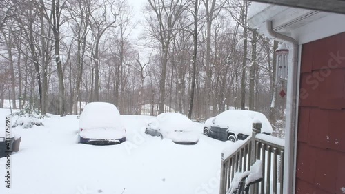 looking at the cars buried in snow through the window photo