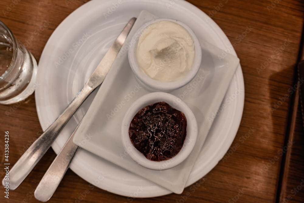 cream cheese and marmalade, on a cafeteria plate cream cheese and marmalade, on a cafeteria plate