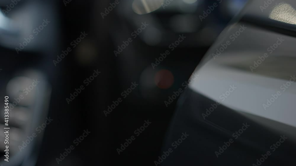 Close-up of unrecognizable girl opening luxurious black car door and sitting inside. Caucasian hand pulling door handle. Child in car dealership or garage. Slow motion. Close-up of unrecognizable girl opening luxurious black car door and sitting inside. Caucasian hand pulling door handle. Child in car dealership or garage. Slow motion.