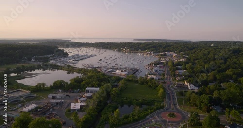 Flying Over Huntington and Towards Boats Docked at Bay During Sunset