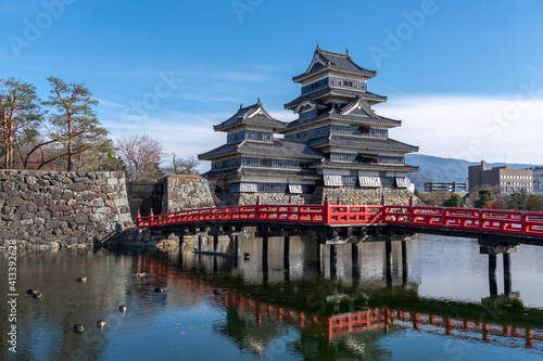 The Matsumoto Castle as seen from the bridge with the city buildings in the background, Japan