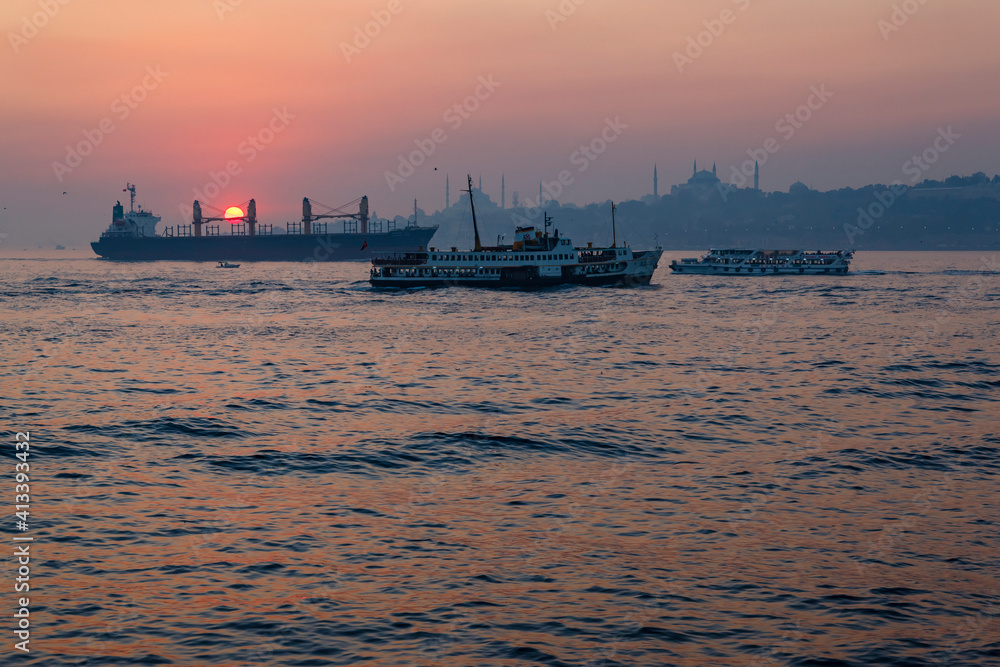 Ships against the old city at sunset on the Bosporus, Istanbul, Turkey.