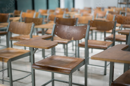 Wooden chairs are well arranged in the classroom. Empty classroom with vintage tone wooden chairs. Back to school concept.. © EduLife Photos