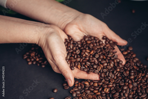 brown coffee beans in hands arabica drink preparation