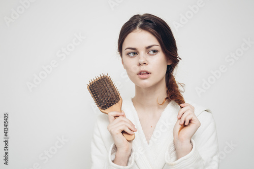 woman holding a comb in her hand and tangled hair fragility health problems