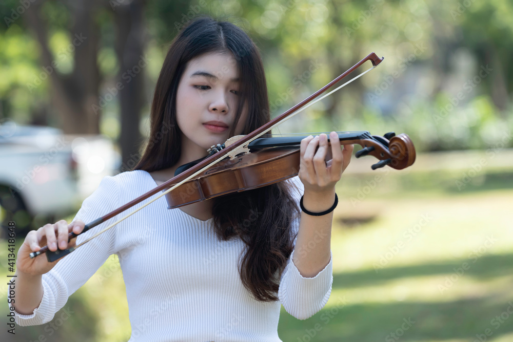 Beautiful woman hold violin on nature view background, in emotion feeling happy. Beautiful woman hold violin on nature view background, in emotion feeling happy.