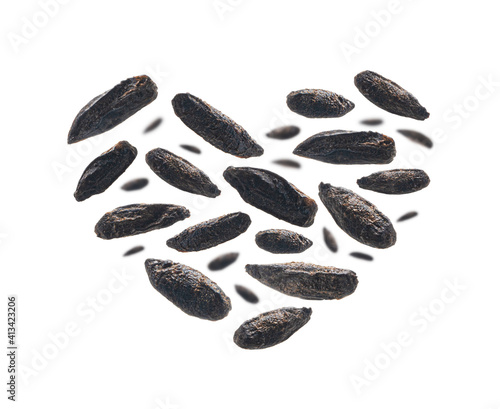 Roasted rye malt grains in the shape of a heart on a white background photo