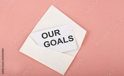 Word Writing Text OUR GOALS on card on the pink background