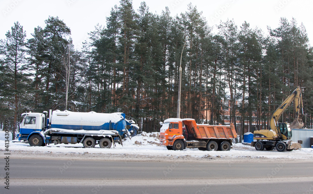 heavy trucking equipment in winter in the parking lot