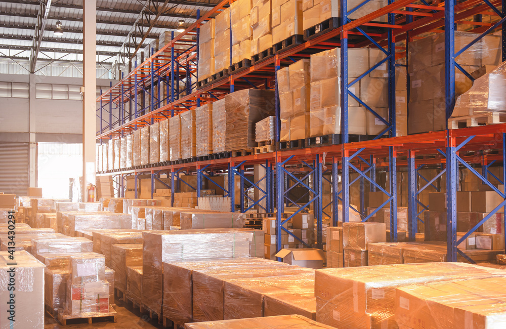 Interior of storage warehouse with tall shelves. Cargo shipment boxes. 