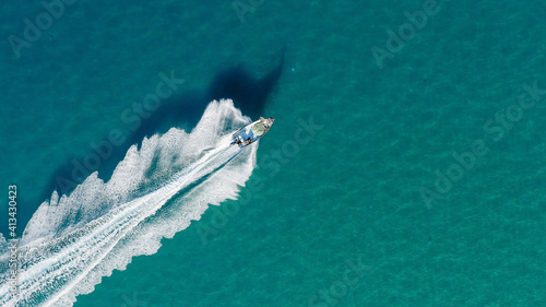 Bilde på lerret Small Fishing boat roaring across calm smooth Sea, Aerial view.