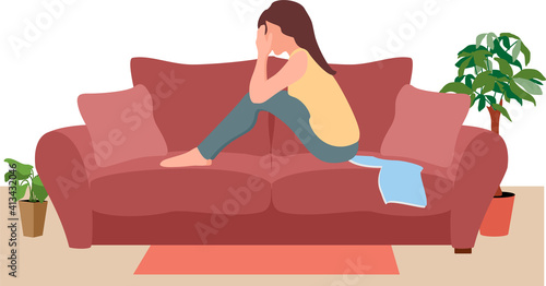 Sad girl hug knees sit on couch feels lonely. Unhappy young woman suffers sitting on couch alone.