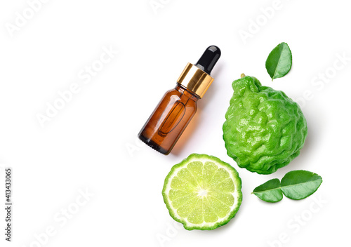 Flat lay (top view) of Bergamot essential oil with bergamot fruit isolated on white background. photo